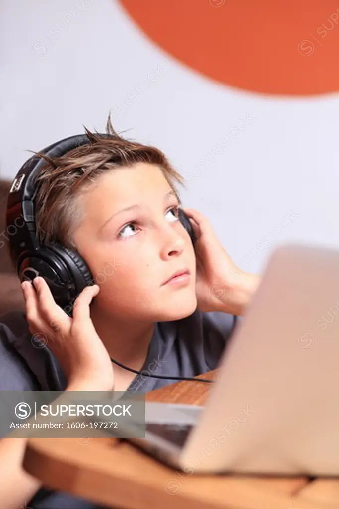 France, Boy Listening To Music With A Computer.
