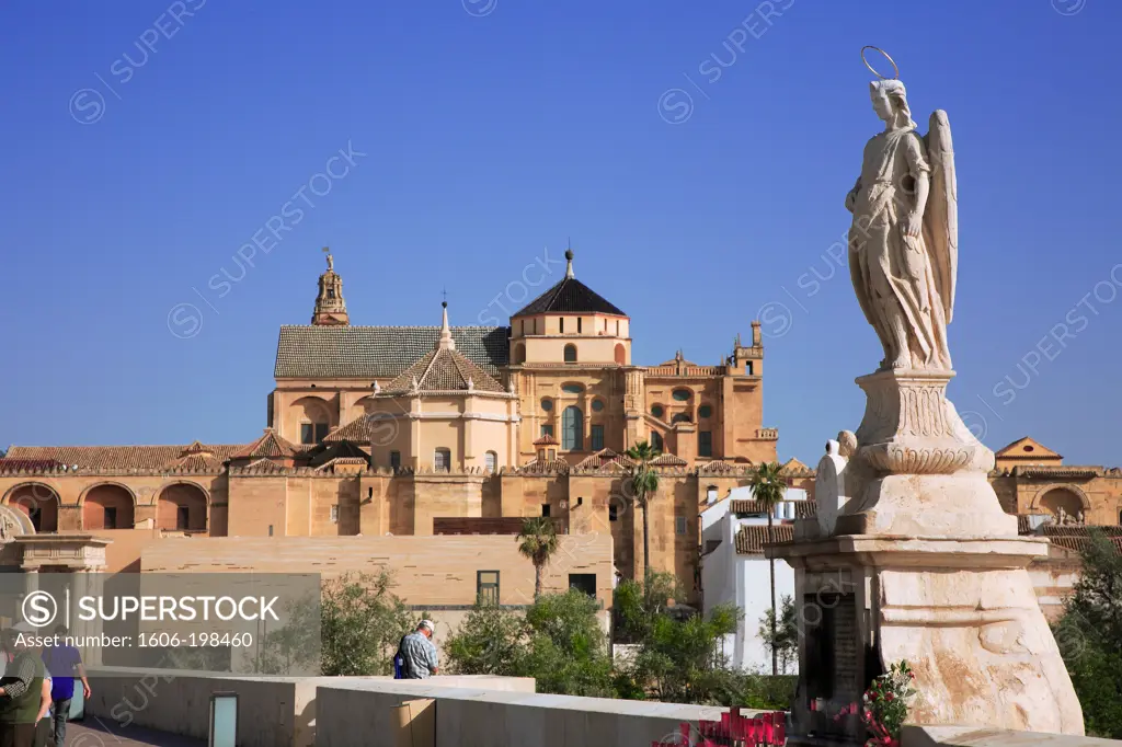 Spain, Andalusia, Cordoba, View Of The Great Walls Of The Mosque-Cathedral Of Córdoba And Sculpture Of Raphael From The Roman Bridge