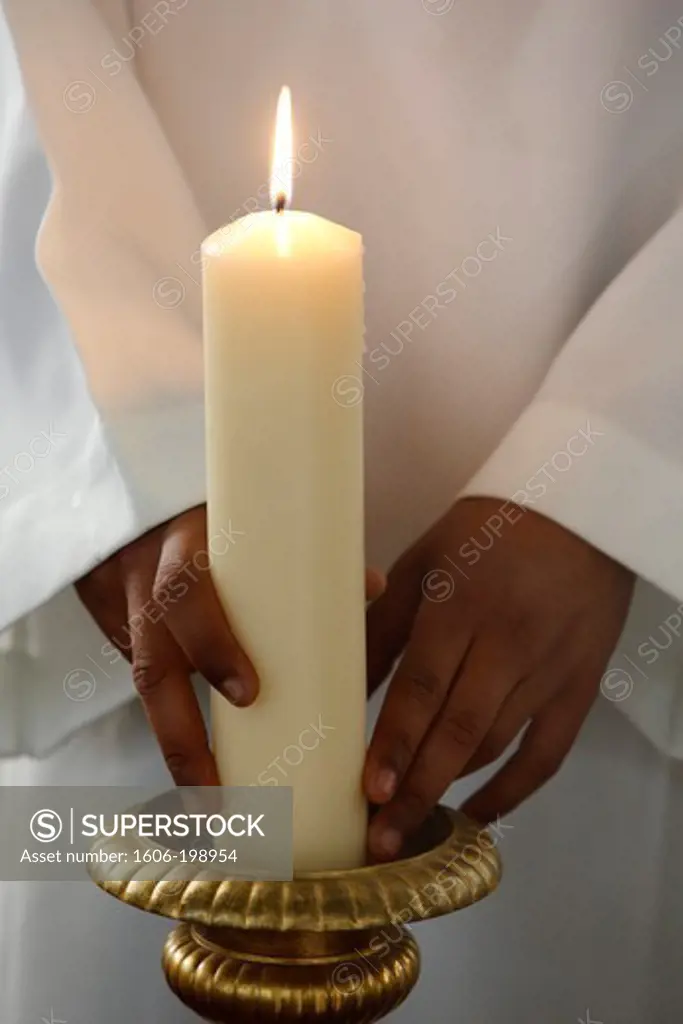 Altar Boy Placing A Church Candle