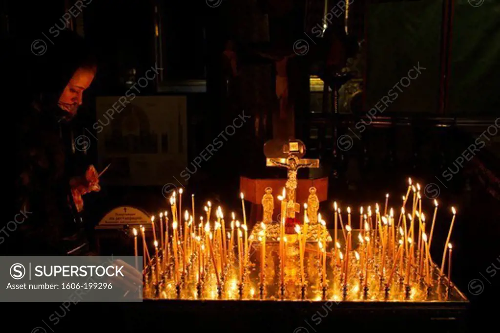 Kazan Cathedral. Orthodox Woman Lights Candles. Saint Petersburg. Russia.