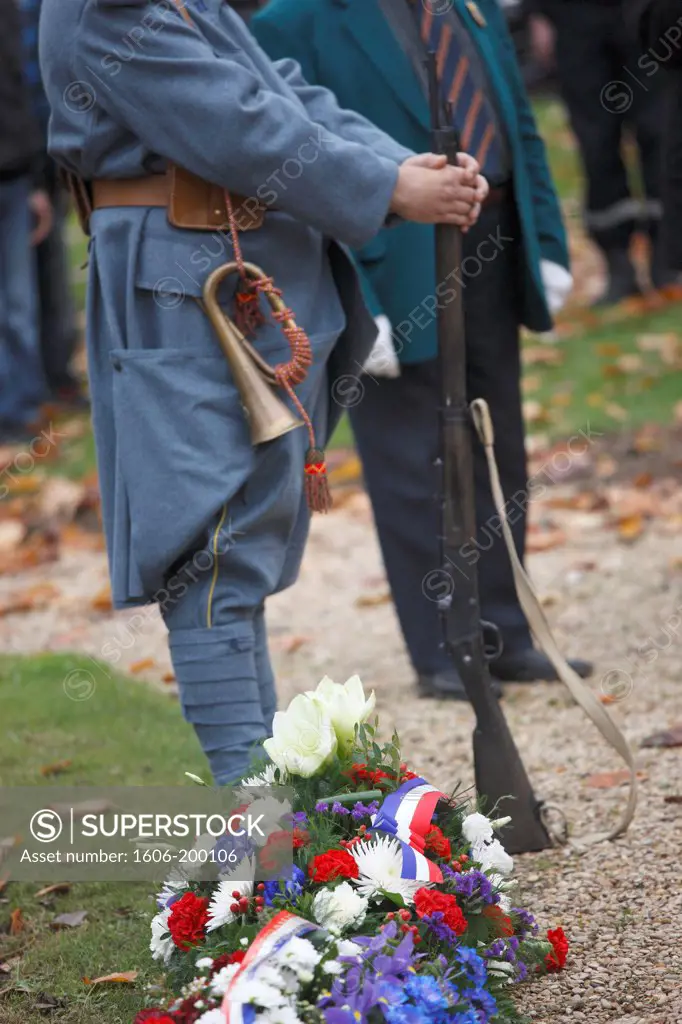 France. Seine Et Marne. Coulommiers. Celebrations Of November 11Th. Man Wearing First World War Army Costume. Flowers At His Feet.