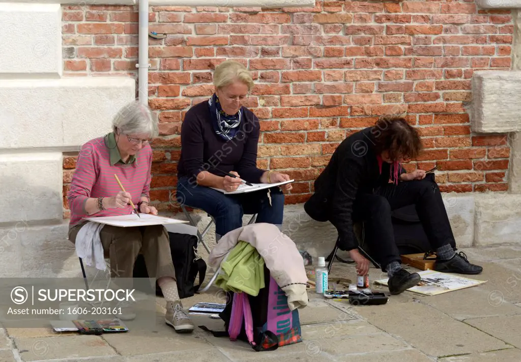 Women Drawing In A Public Street Of Venice, Italy, Europe
