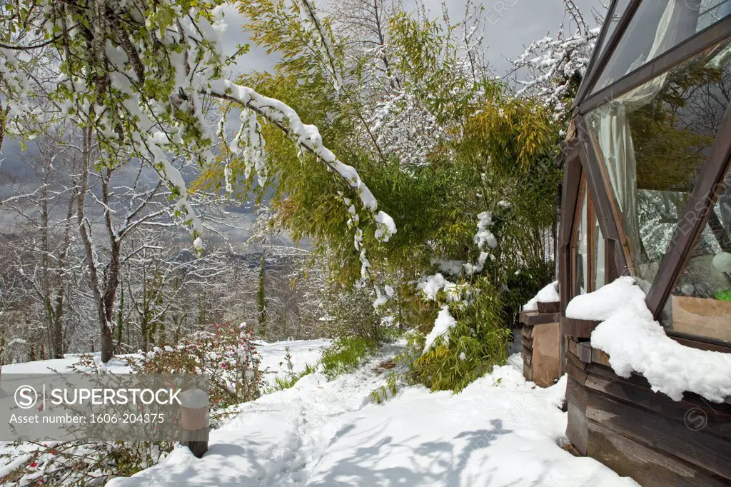 France, Ariege, Pyrenees,geodesic dome homecovered in snow, private garden