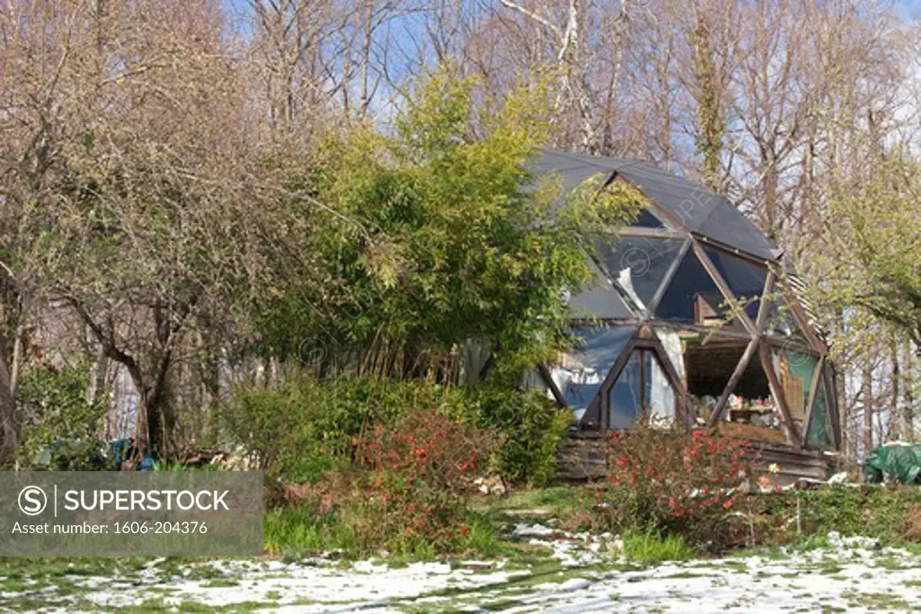 France,Ariege, Pyrenees, geodesic dome homecovered in snow, blooming Japanese quince