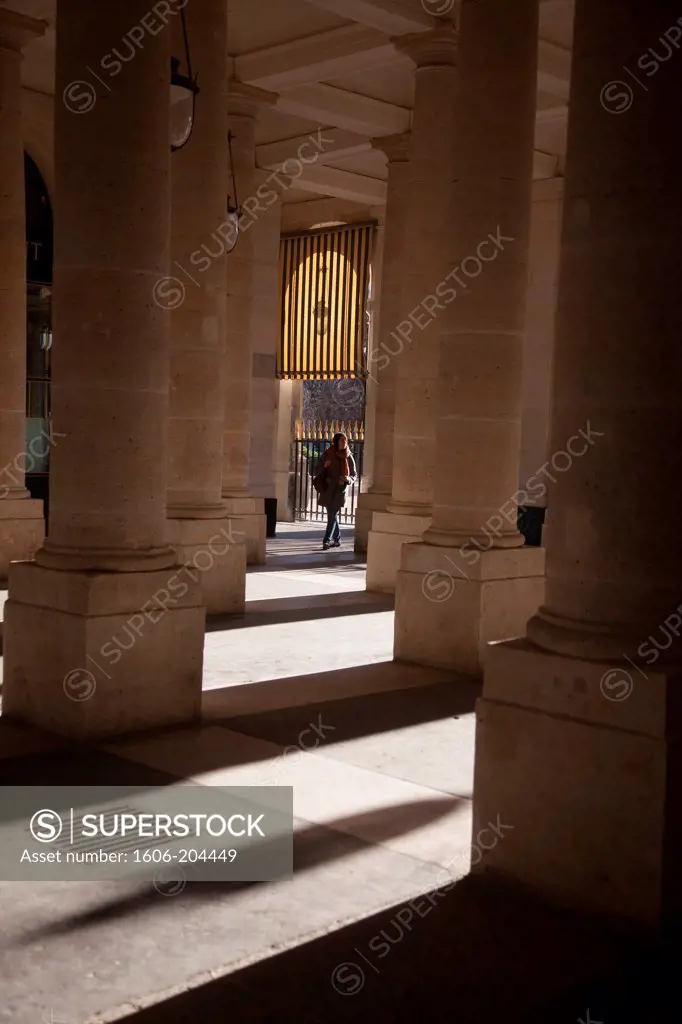 France. Paris, 1st district , Royal palace Garden,Showadows of the pedestrians under the arches