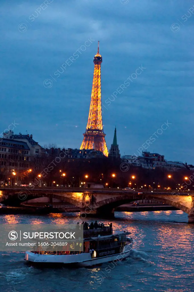 France, Paris, Eiffel Tower at dusk, Bateau-mouche on the Seine River