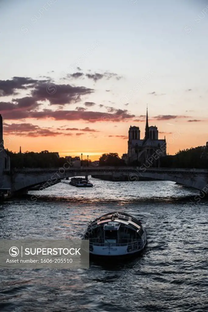 France. Paris. 4th district. Bateau-mouche on the Seine River, Notre Dame Cathedral in the background