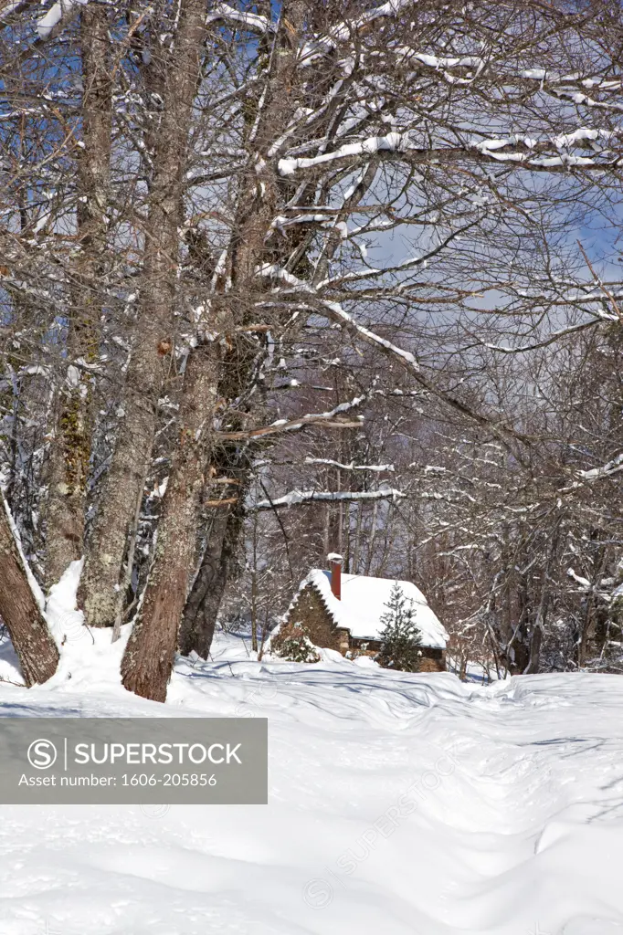 France, Ariege, old stone house in a snowy landscape