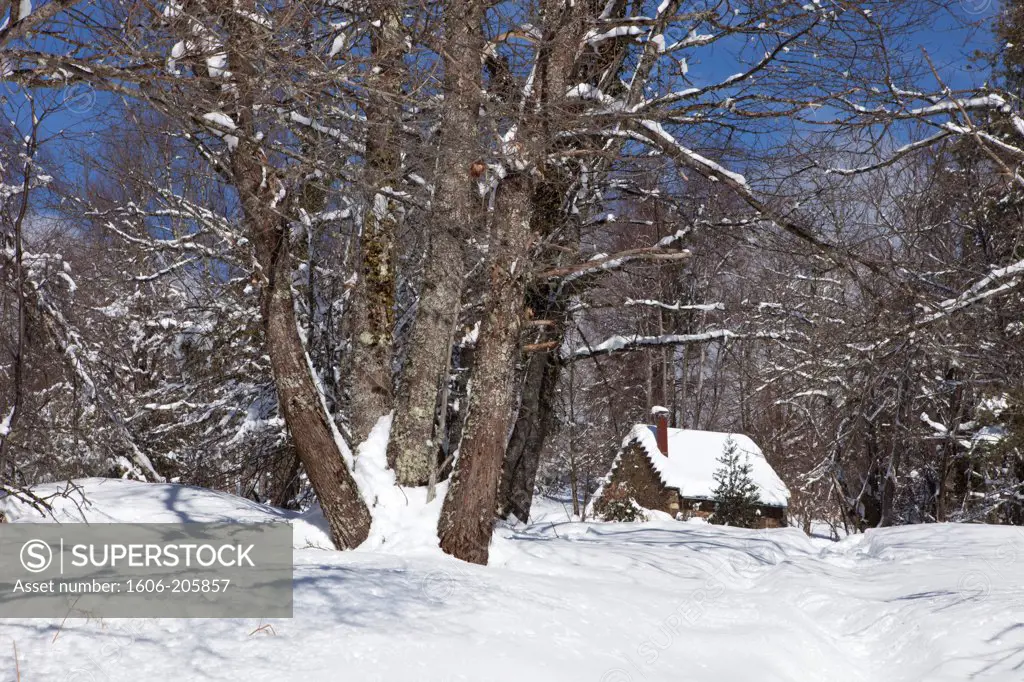 France, Ariege, old stone house in a snowy landscape