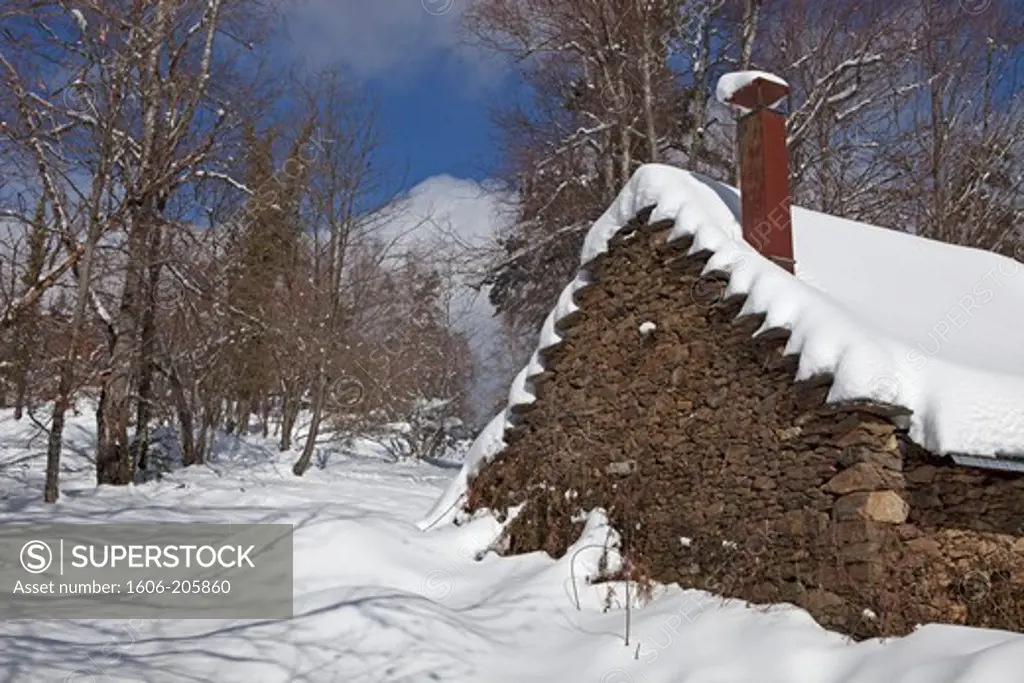 France, Ariege, Old stone house in a snowy landscape