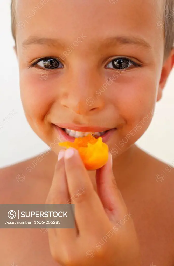 6-year-old boy eating an apricot Lecce. Italy.