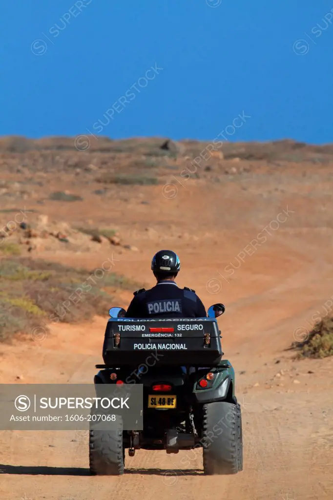 Western Africa,Republic of Cape Verde, Sal island. Santa Maria. Cop of the touristic police on a quad.