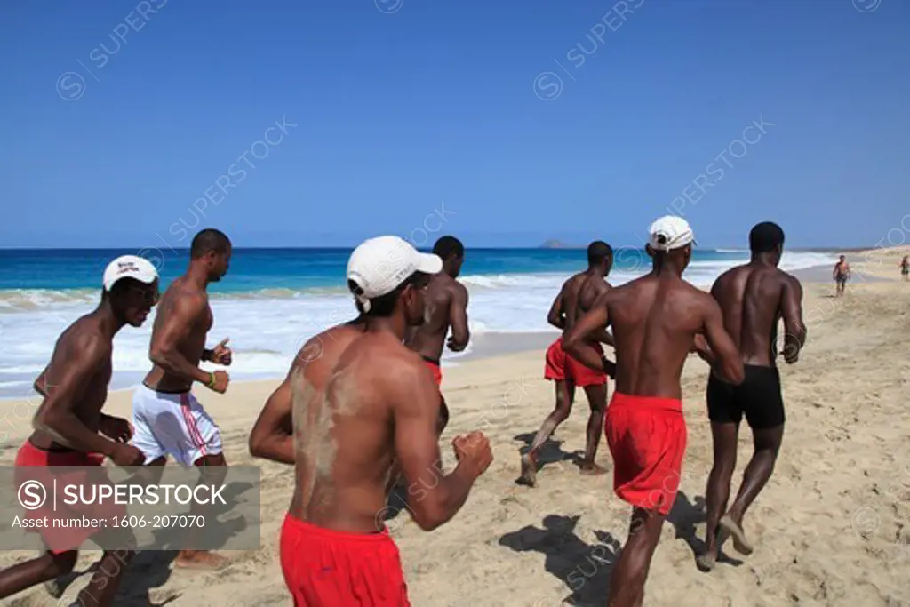 Western Africa,Republic of Cape Verde, Sal island. Santa Maria. Local sportsmen running on the beach.