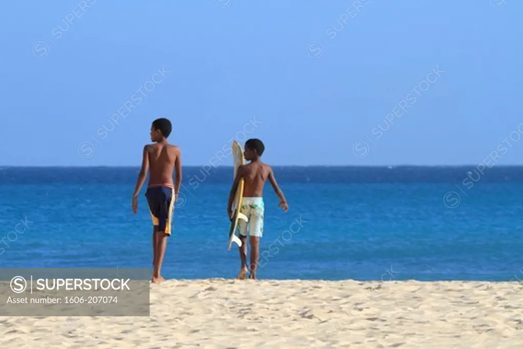 Western Africa,Republic of Cape Verde, Sal island. Santa Maria. Kids going surfing.
