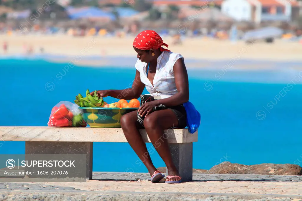 Western Africa,Republic of Cape Verde, Sal island. Santa Maria. woman selling fruits ion the jetty.