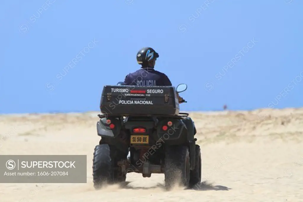 Western Africa,Republic of Cape Verde, Sal island. Santa Maria. Cop of the touristic police on a quad.