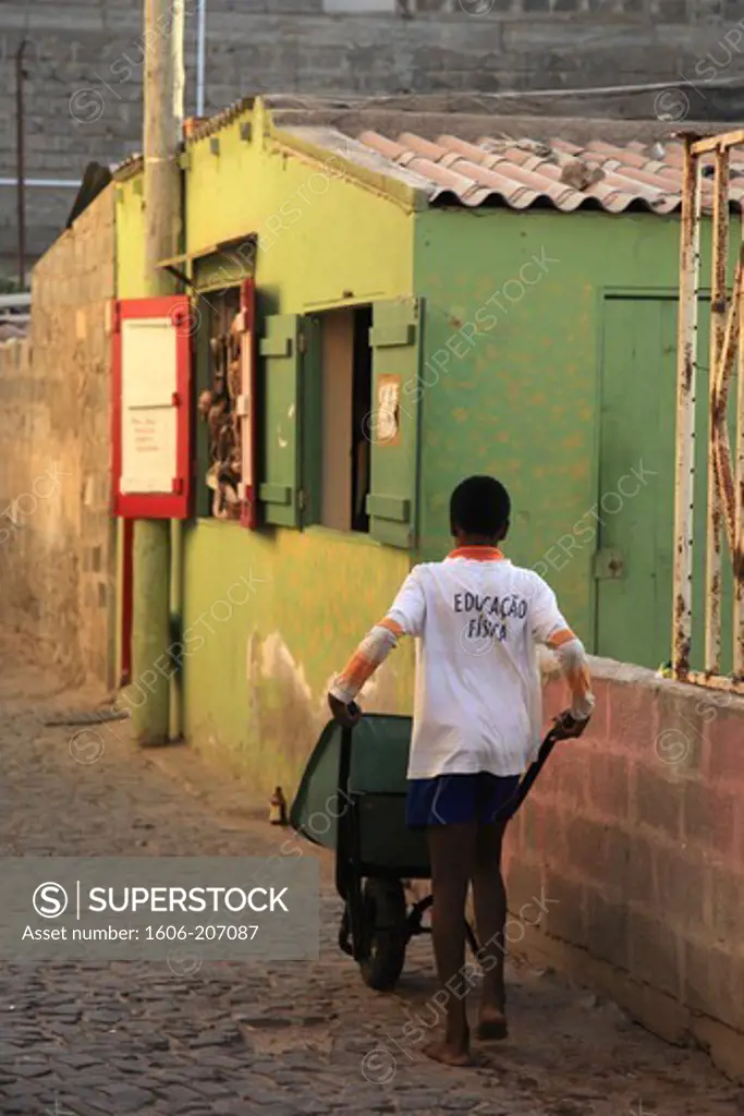 Western Africa,Republic of Cape Verde, Sal island. Santa Maria. Kid with a wheelbarrow.