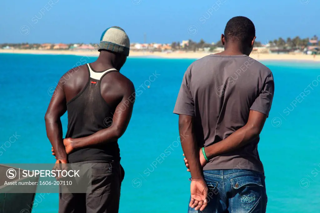 Western Africa,Republic of Cape Verde, Sal island. Santa Maria. Two men waiting on the jetty.