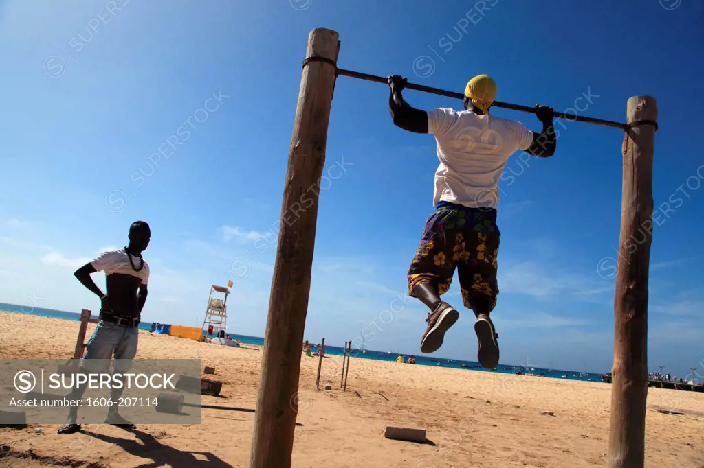 Western Africa,Republic of Cape Verde, Sal island. Santa Maria. People exercising on village beach.
