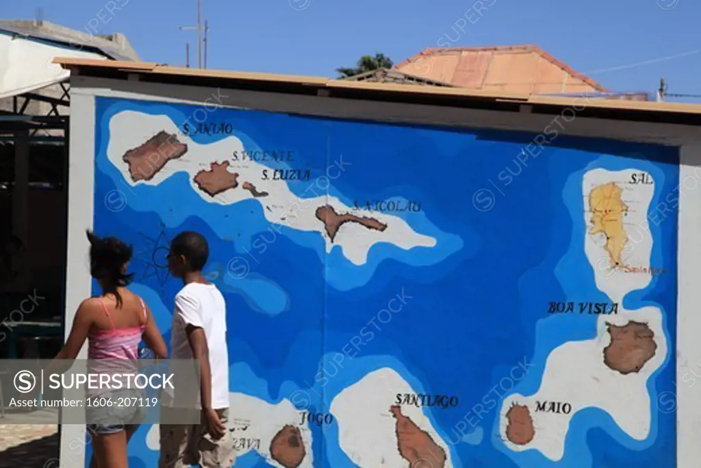 Western Africa,Republic of Cape Verde, Sal island. Santa Maria. Passer-by in front of island's map.