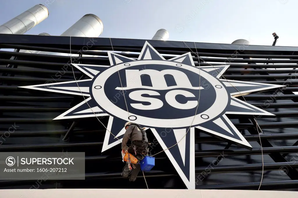 France, Pays de la Loire, STX shipyards in Saint-Nazaire, delivery of MSC Preziosa giant liner, member of the crew cleaning MSC sign company on board the ship.