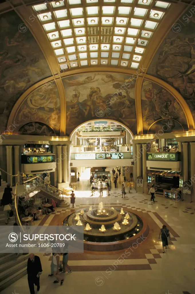 Argentina, Buenos-Aires, inside of the Galerias Pacifico commercial center, stores, pond and fountain, passers-by