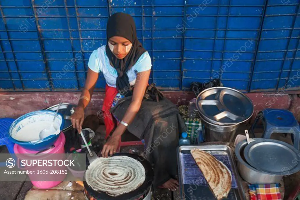 Myanmar,Yangon,Woman Cooking Indian Style Crepes