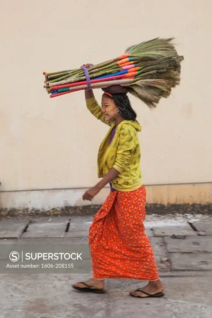 Myanmar,Yangon,Woman Carrying Brooms on Head