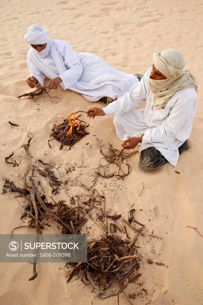 Africa, Tunisia,Beduins sitting by a fire in the Sahara Tunisia.