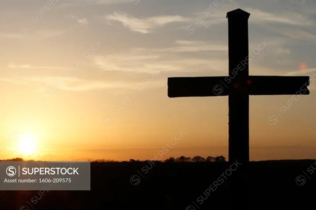 Cross at sunset. France.
