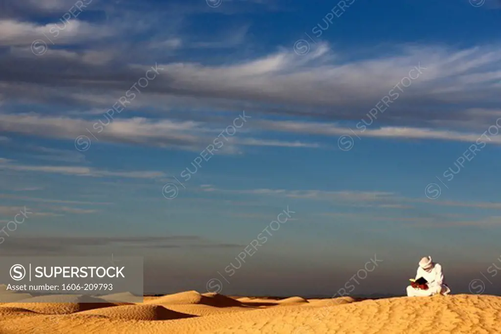 Beduin reading the Coran in the Sahara Tunisia.