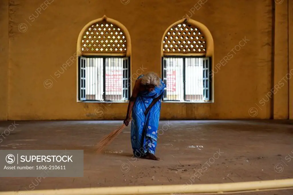 Old woman cleaning the floor at  Thirumalai Nayak Palace in Madurai, Tamil Nadu,South India,Asia