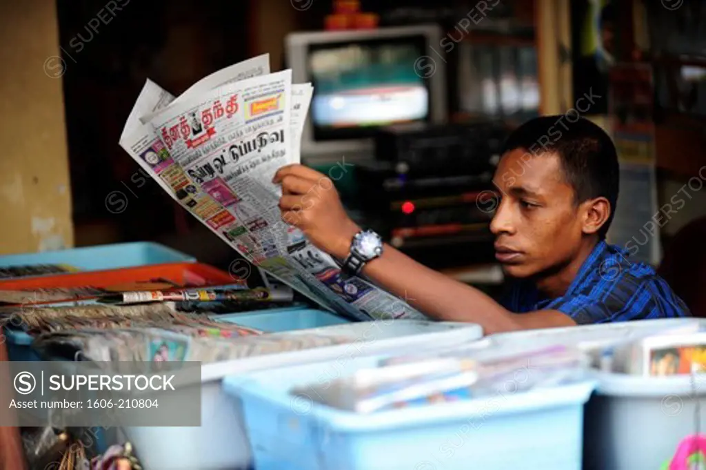 Man reading a newspaper in Madurai, Tamil Nadu,South India,Asia