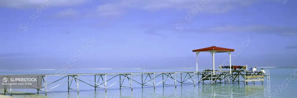 Mauritius, Morne Brabant beach, 3 men sitting on a pier