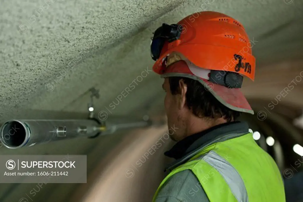 Belgium, Antwerp city, tunnel boring, worker checking pipe