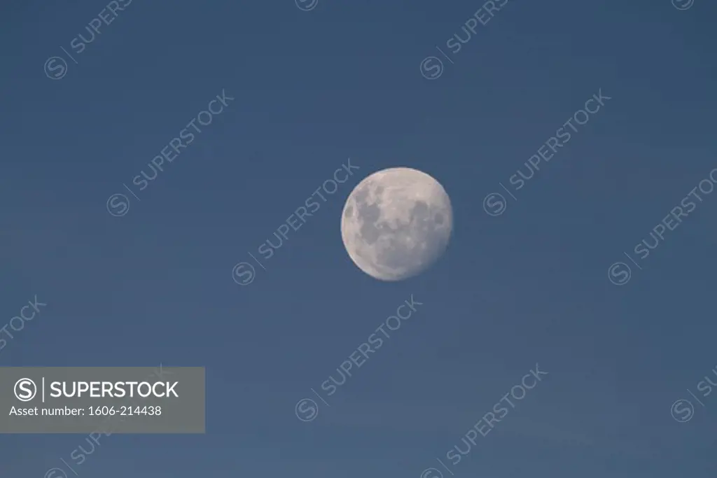 Full moon in a blue sky.