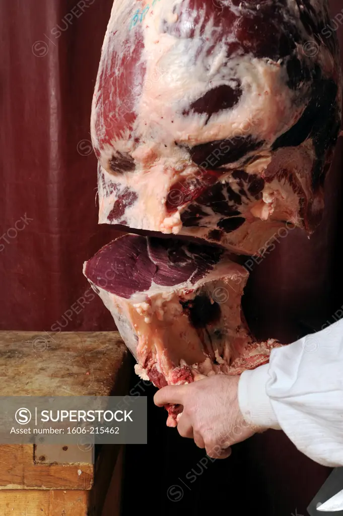 France, Paris, a butcher carves a thigh of beef