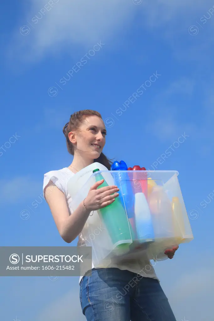 France, young woman with plastic items for waste sorting.