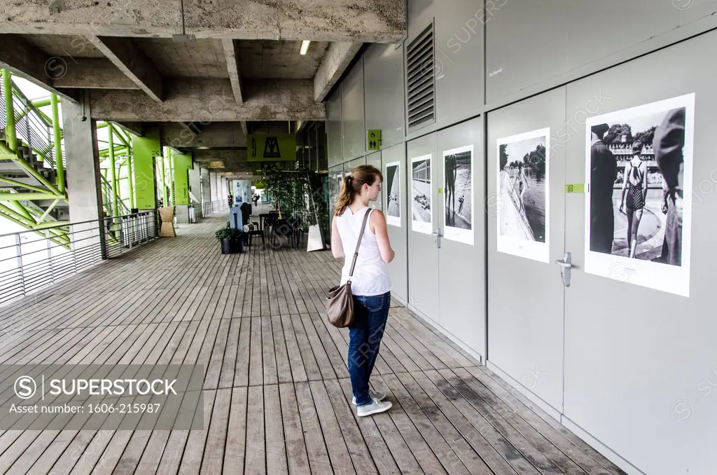 Young woman visiting a photography exhibition at the Cité de la Mode et du Design, Paris 13th district, France