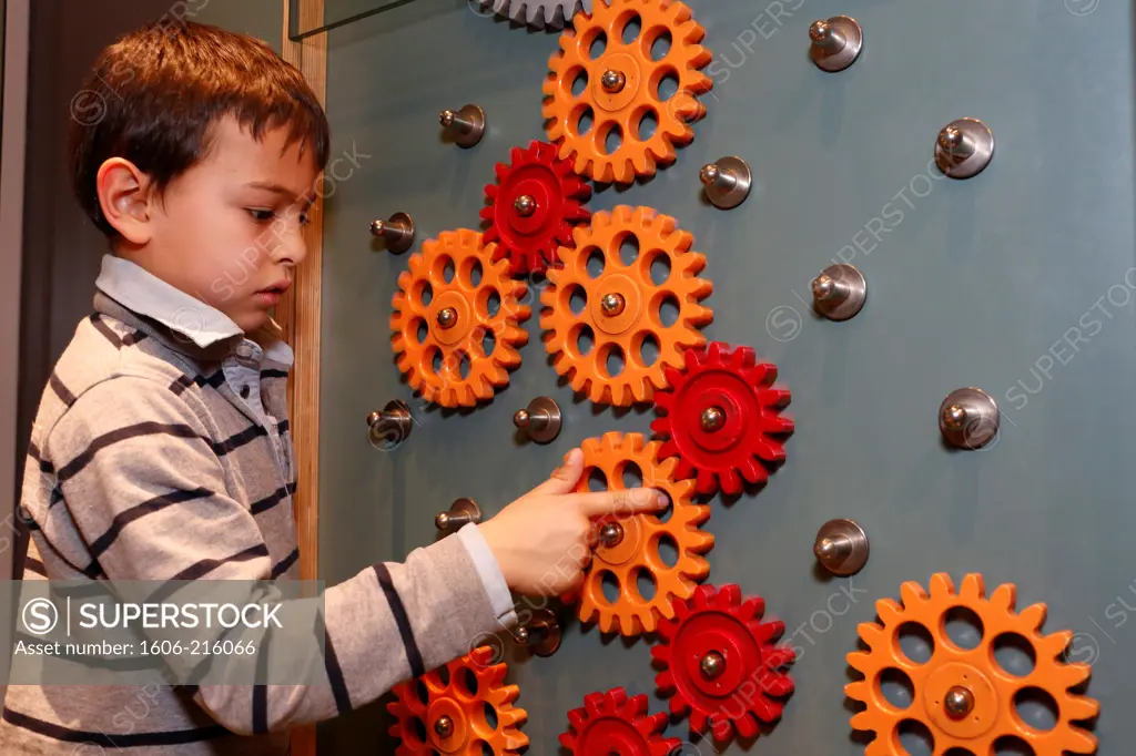 Boy having fun and educational activities at la Cité des Sciences, Paris France.