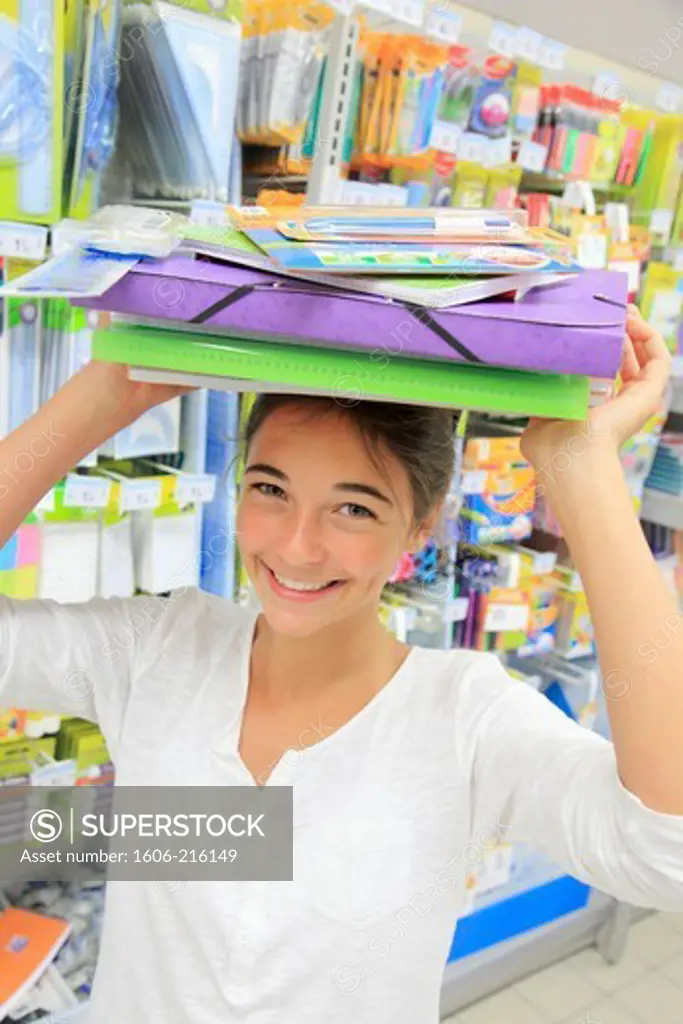 France, young girl in a supermarket, shopping for school.