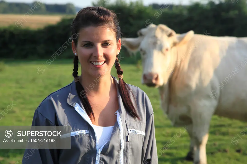 France, young woman farmer posing smiling.