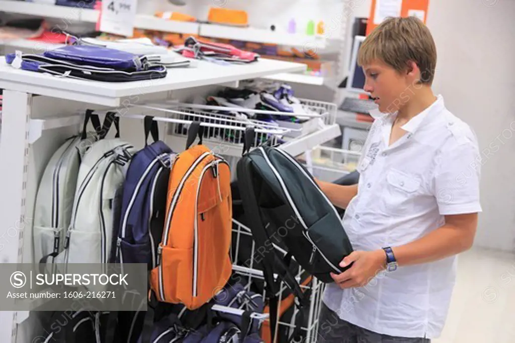 France, schoolboy choosing a portfolio in a supermarket.