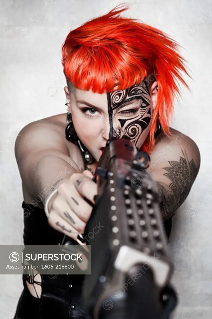 DeathWorker, a Cyberpunk red hair woman with tattoo and gun in a studio