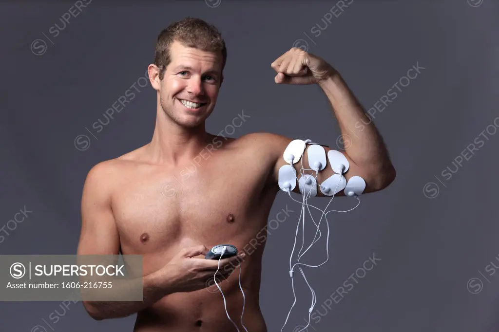 France, young man doing electrical muscle stimulation.