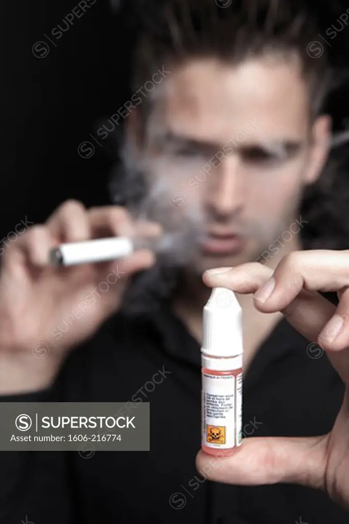 France, young man smoking an electronic cigarette.