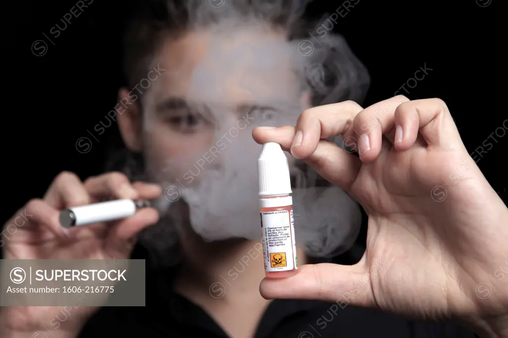 France, young man smoking an electronic cigarette.