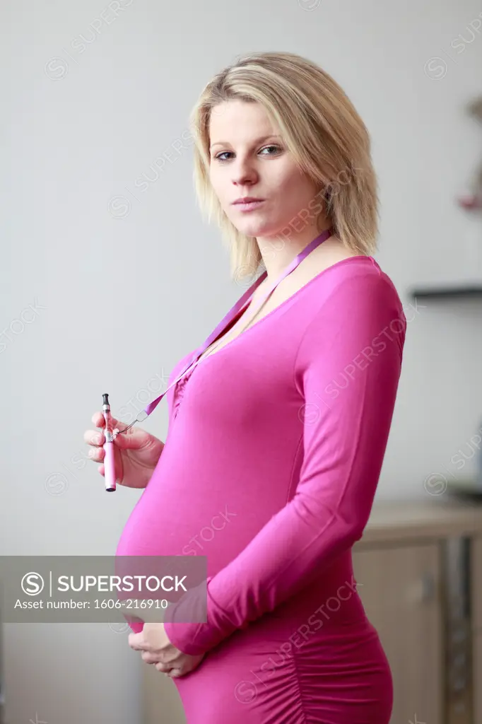 France, pregnant woman holding electronic cigarette.
