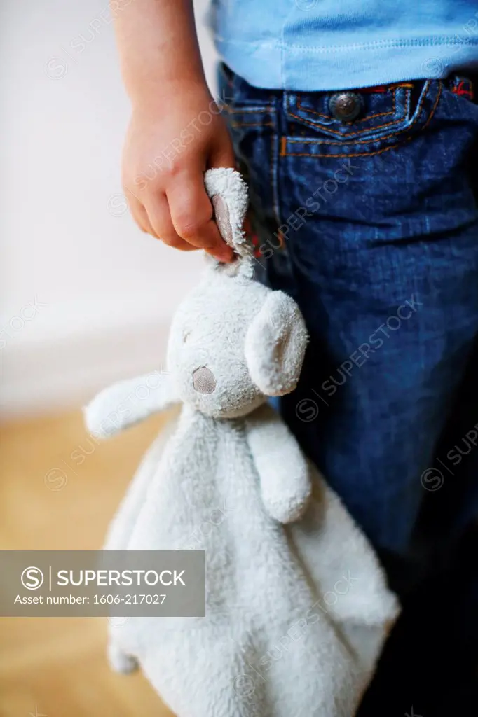 A cuddly toy in the hands of a little boy
