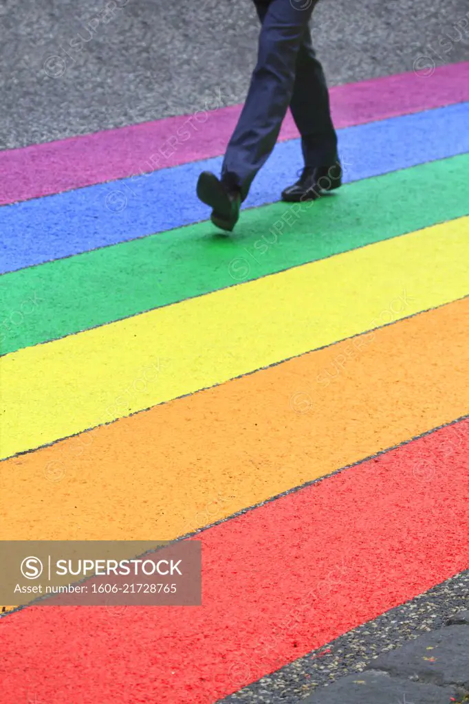 Man walking on color stripes, llike a rainbow flag